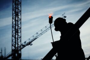 silhouette of man holding flamethrower